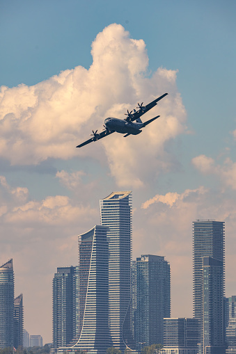 Toronto, Ontario - September 3, 2022 : Royal Canadian Air Force c-130j Super Hercules flying in front of Humber Bay waterfront