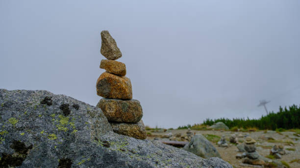 istock Many stone statues, pyramids are piled on the big rock. 1420783602