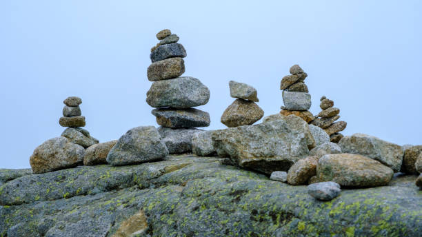 istock Many stone statues, pyramids are piled on the big rock. 1420783607