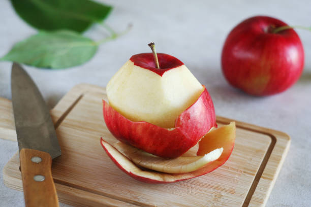istock A peeled apple lies on a wooden board 1420783791