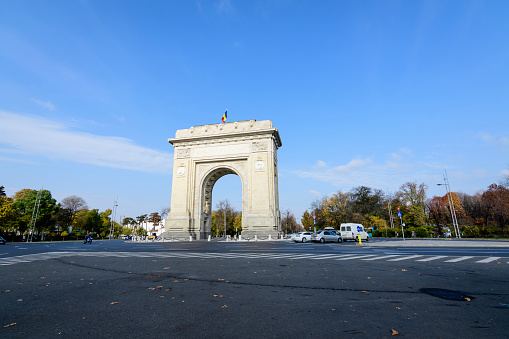 Bucharest, Romania - 6 November 2021:  Arcul de Triumf (The Arch Of Triumph) triumphal arch and landmark, located in the Northern part of the city on Kiseleff Road near King Michael I (Herastrau) Park