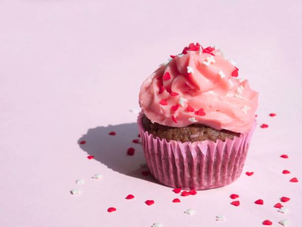 istock Cupcake on a purple background with side lighting and a place for text 1420787385