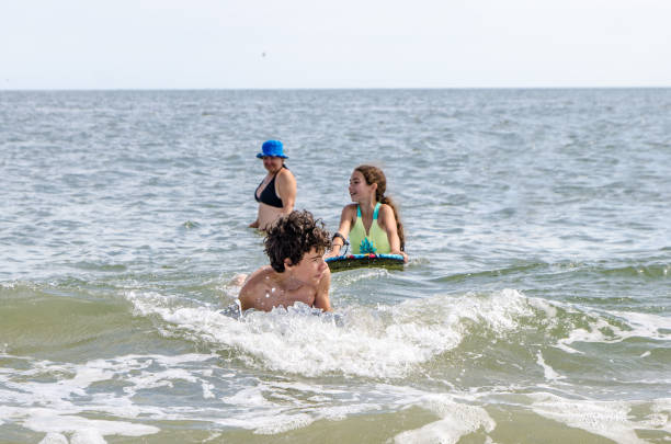 istock Mother and kids playing into Atlantic Ocean 1420788321