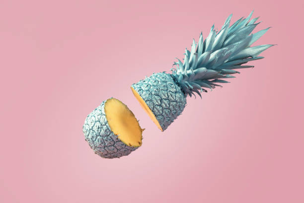 istock Creative food concept. Blue cut pineapple falls on a pink background. 1420788362