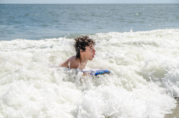 istock Teenage boy surfing into Atlantic Ocean 1420788687