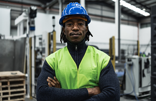 African engineer man working inside robotic factory - Industry concept