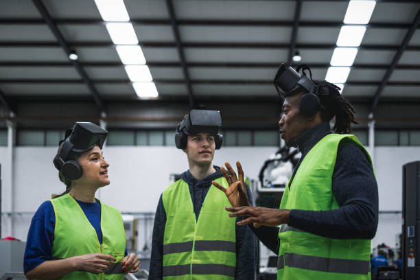 istock Team of engineers having simulation experience with futuristic virtual reality glasses inside robotic factory - Tech industry and metaverse concept 1420791671