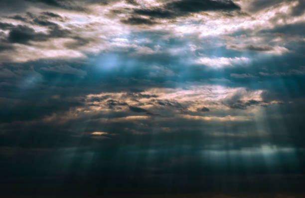 Sun Burst rays break over the clouds shining sunset Beautiful evening  Sunbeams dark rain like under water