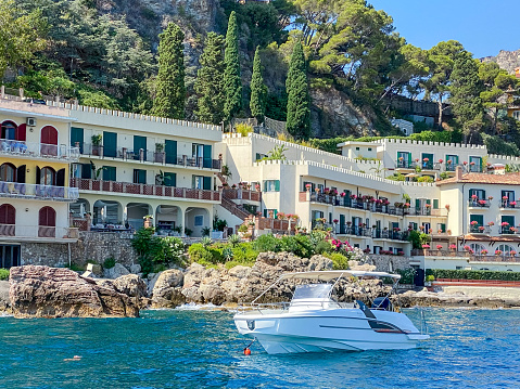 Taormina, Italy - July 22, 2022: Hotels and beaches along coastline below Taormina in Sicily