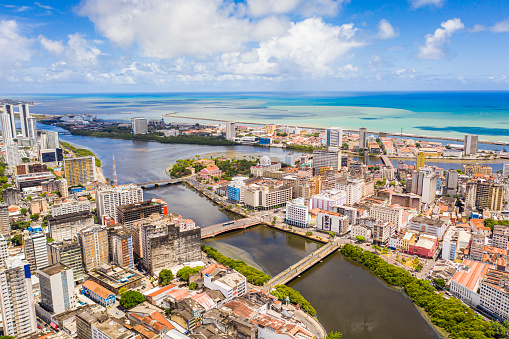 Drone point of view of old town in Recife with the Capibaribe river and the old bridges, Brasil