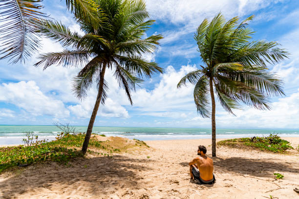Wide angle view of a man standing in the beach of Boa Viagem. Pernambuco