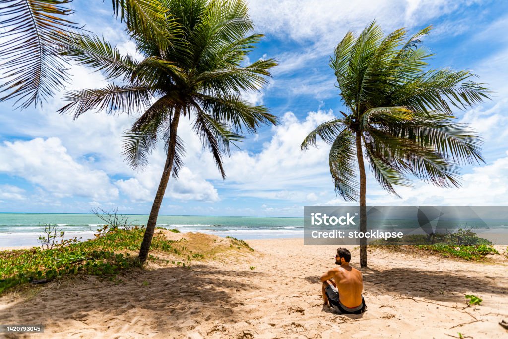 Man alone in the beach of Boa Viagem, Recife Wide angle view of a man standing in the beach of Boa Viagem. Pernambuco Beach Stock Photo