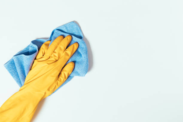 istock Hand wearing glove cleaning surface with towel 1420793488