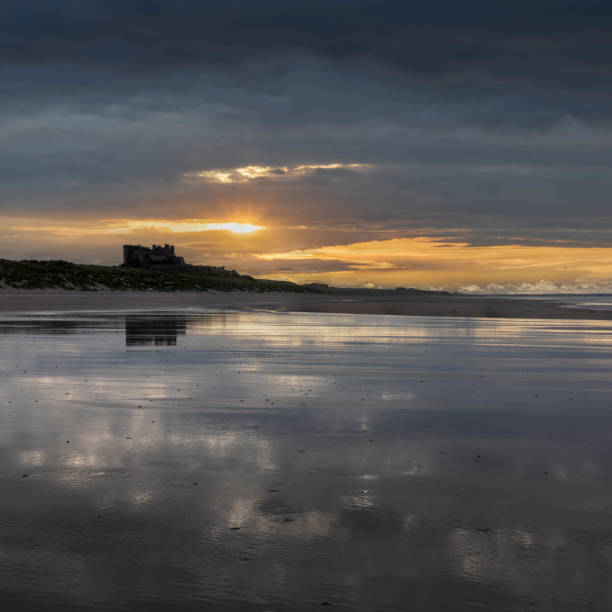 Bamburgh Castle from the south sunset Bamburgh Castle from the beach to the south at sunset with no people Bamburgh stock pictures, royalty-free photos & images