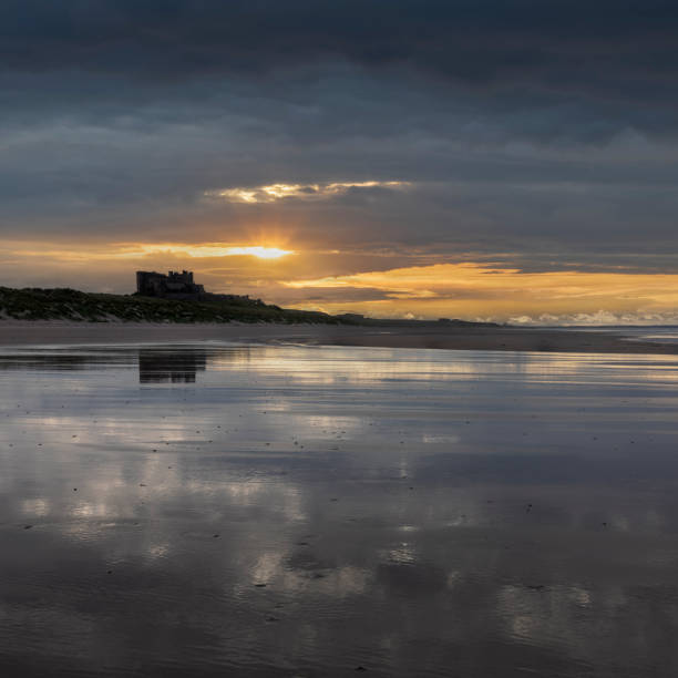 bamburgh castle from the south sunset - bamburgh beach imagens e fotografias de stock