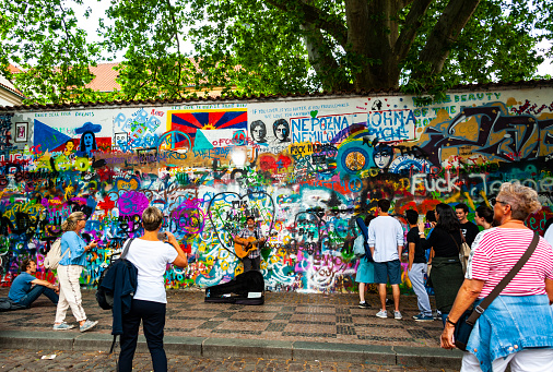 Prague, Czech Republic - May 12, 2018:  View of the Lennon Wall in Prague, Czech Republic. Since the 1980s this wall has been filled with John Lennon-inspired graffiti.