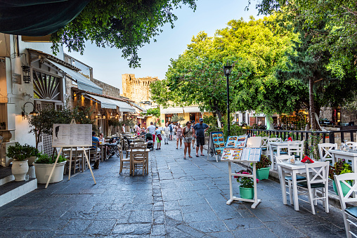 Rhodes Island, Greece - May 25, 2022: The street with restaurants next to each other in the old town area of Rhodes island, Greece.