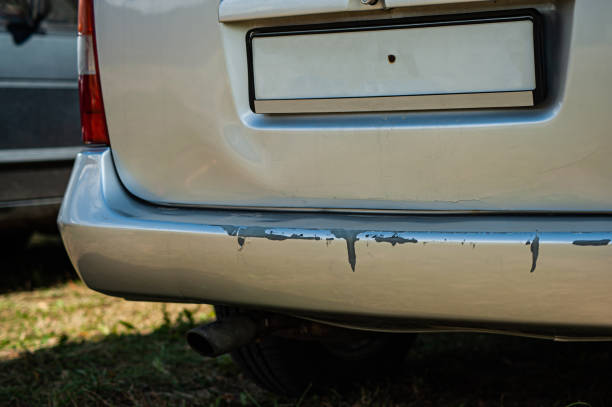 istock car crash or accident. Front fender and light damage and scratched on bumper. Broken vehicle detail or close up 1420797746