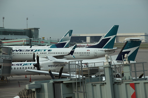 West Jest Airplanes at the gate at Toronto Canada's, Pearson International Airport on an overcast day