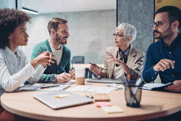 istock Senior business woman working with her team 1420800962