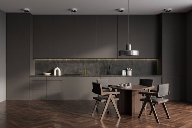 istock Grey kitchen interior with eating table and seats on wooden floor 1420801656