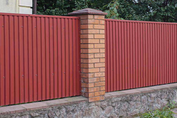 istock long fence wall made of metal and red bricks 1420802028