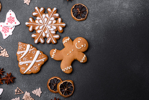 Christmas decorations and gingerbreads on a dark concrete table. Preparing and decorating the house for holiday