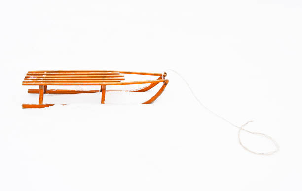 Wooden sled on white snow
