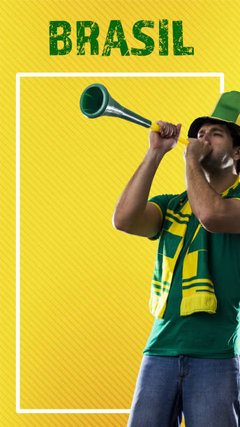 istock brazilian player, man celebrating on a yellow background. 1420808877
