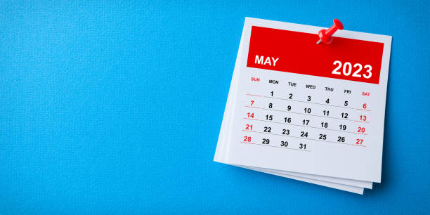 istock White Sticky Note With 2023 May Calendar And Red Push Pin On Blue Background 1420809021