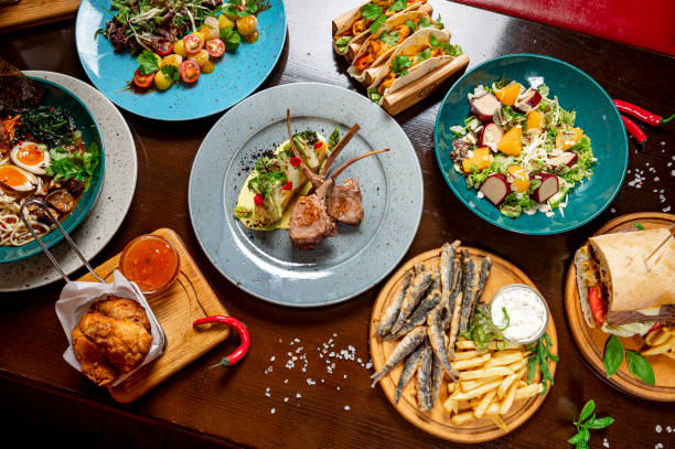 istock Different colorful meals on dark wooden table in the restaurant. 1420809931