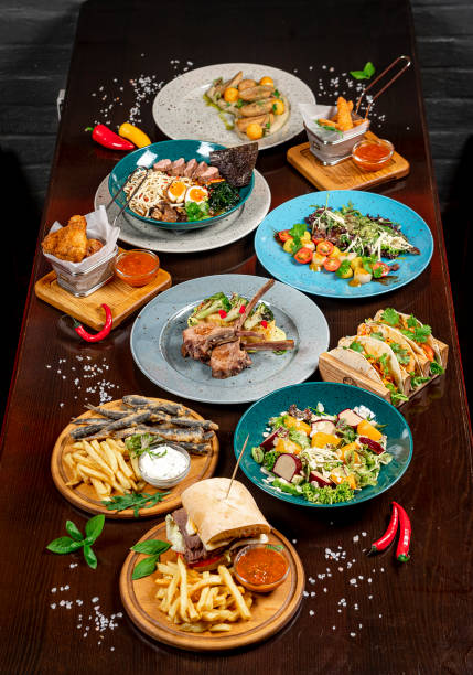 istock Different colorful meals on dark wooden table in the restaurant. 1420809957