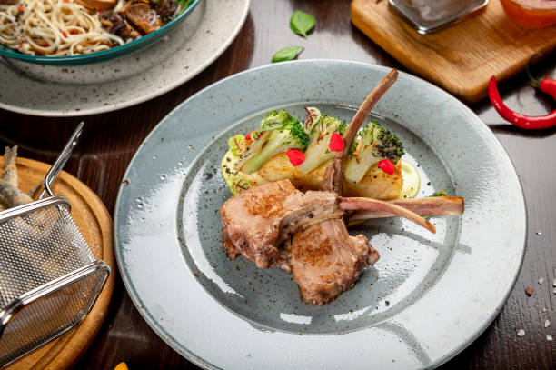 istock Different colorful meals on dark wooden table in the restaurant. 1420810528