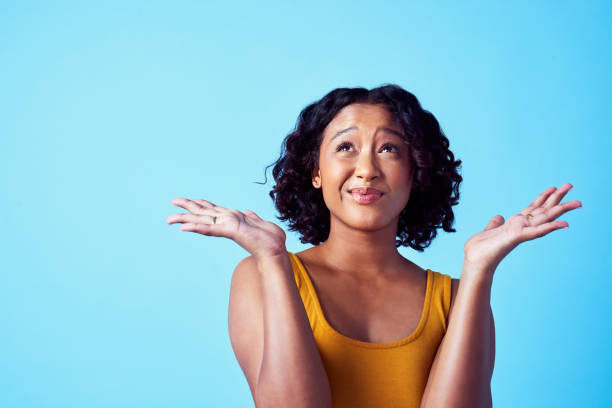 istock Creative, thoughtful and confused black woman thinking while standing in studio with copy space. Young lady in doubt with questions about the future. Student working on strategy or solution in mind. 1420812397