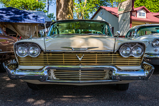 Falcon Heights, MN - June 17, 2022: Low perspective front view of a 1958 Plymouth Fury Golden Commando Coupe at a local car show.