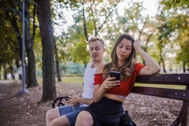 istock Young couple with smartphones ignoring each other 1420815908
