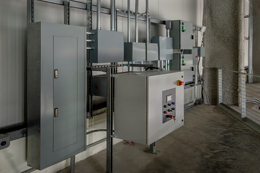 Electrical room with transformer and panels.