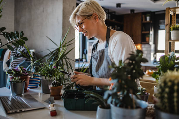 istock Young botanist watching online instructions for plant maintenance 1420824135