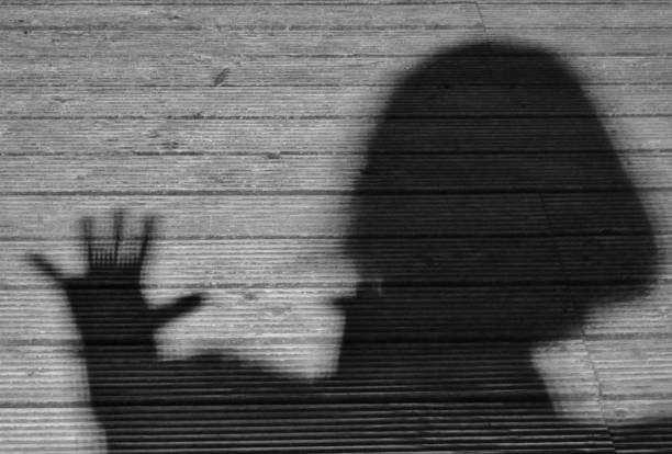 istock shadow of a woman with hand 1420830634