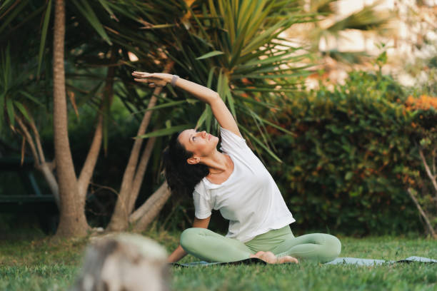 istock Young woman practicing yoga in park 1420834871