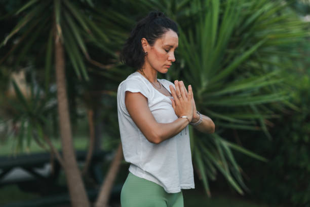 istock Young woman practicing yoga in park 1420837927