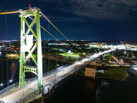 Aerial drone view of a suspension bridge at night. Long exposure.