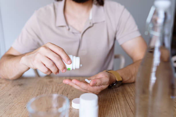 istock Adult man taking medication 1420840752