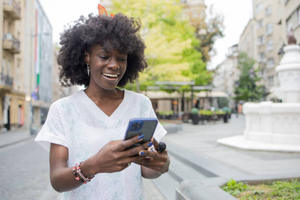 istock Happy young woman using phone 1420840822