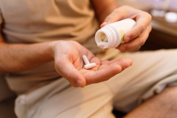 istock Adult man taking medication 1420841281