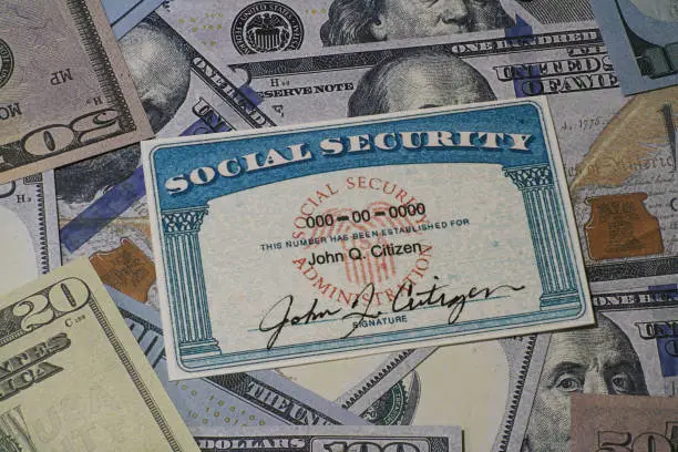 Photo of Lake Elsinore, CA, USA - January 30, 2022: Fake Social security card on prop fake US currency