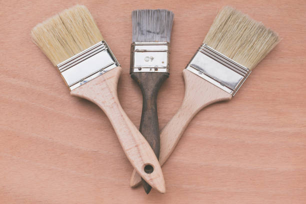 istock Top view of three brushes on a wooden table. 1420844938