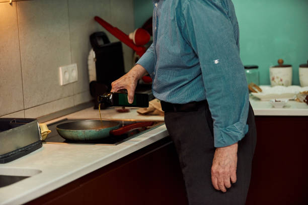 istock An elderly man prepares a meal in the kitchen 1420844950