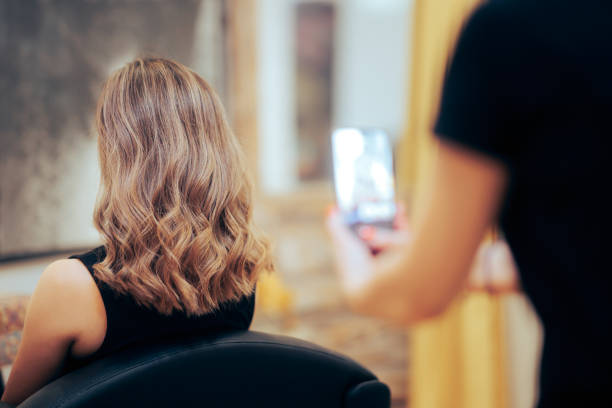 Hairdresser Taking a Picture After Coloring Hair Job stock photo