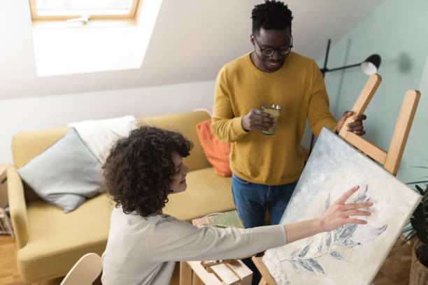 istock African American man supporting her girlfriend while painting 1420850826